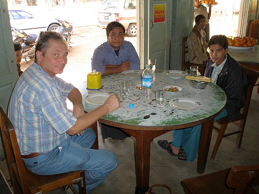P1060018.JPG - Lunch on the way to Mt. Popa. We had no idea what we were ordering. It tasted good. We got a roll of toilet paper in a plastic box as serviettes. The boy sitting on the right is the son of our driver. He came for the day.
